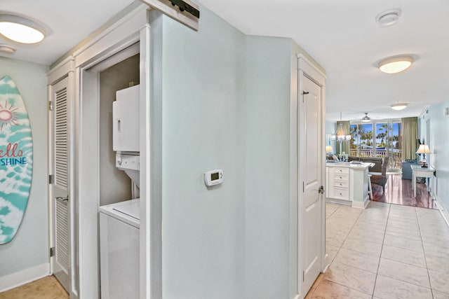1110 Santa Rosa Blvd Unit C303, Fort Walton Beach, FL 32548 - hall featuring stacked washing machine and dryer and baseboards