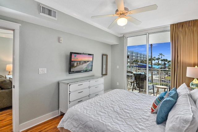 1110 Santa Rosa Blvd Unit C303, Fort Walton Beach, FL 32548 - bedroom featuring access to exterior, wood finished floors, crown molding, expansive windows, and ceiling fan