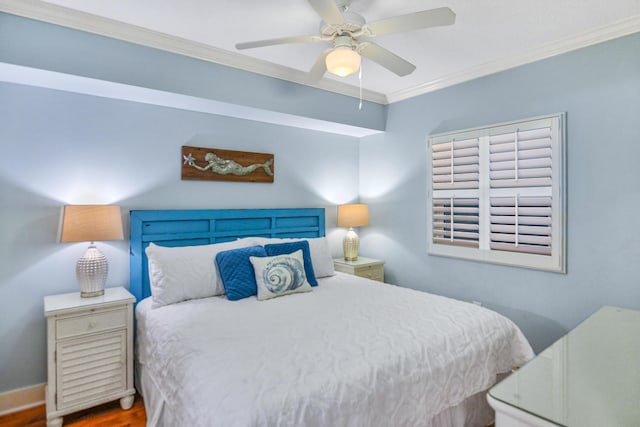 bedroom featuring hardwood / wood-style flooring, ceiling fan, and crown molding