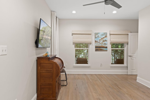 sitting room with ceiling fan, light hardwood / wood-style flooring, and a healthy amount of sunlight