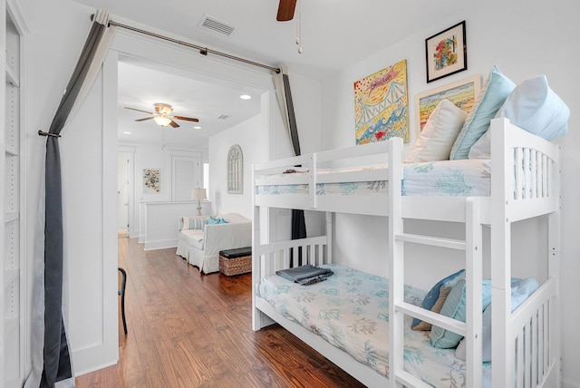 bedroom with ceiling fan and dark hardwood / wood-style flooring