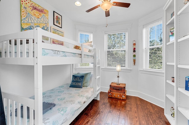 bedroom with ceiling fan and dark wood-type flooring