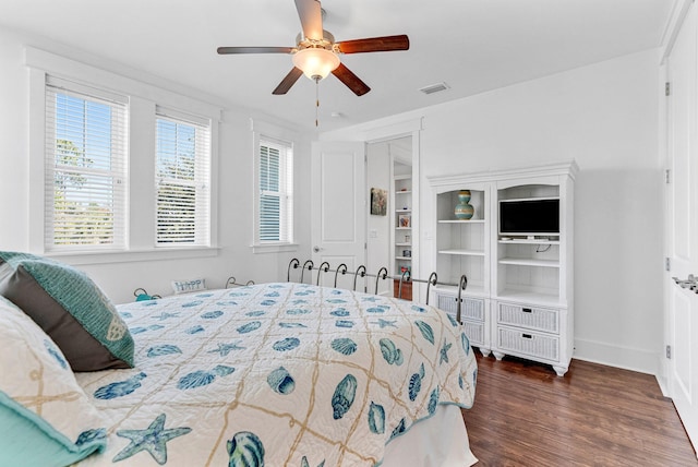 bedroom with a closet, ceiling fan, and dark wood-type flooring