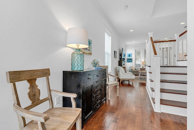 foyer entrance with dark hardwood / wood-style flooring and crown molding