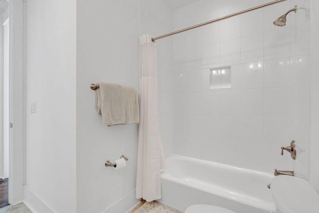 bathroom with toilet and shower / bath combo with shower curtain