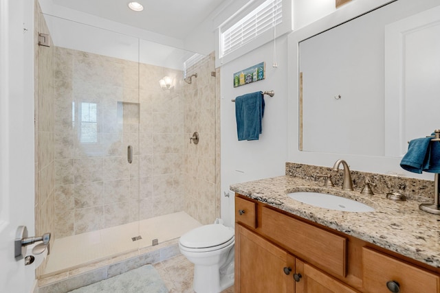 bathroom with an enclosed shower, vanity, toilet, and tile patterned floors