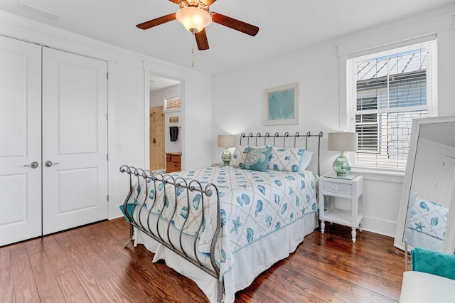 bedroom featuring a closet, ceiling fan, and dark hardwood / wood-style flooring