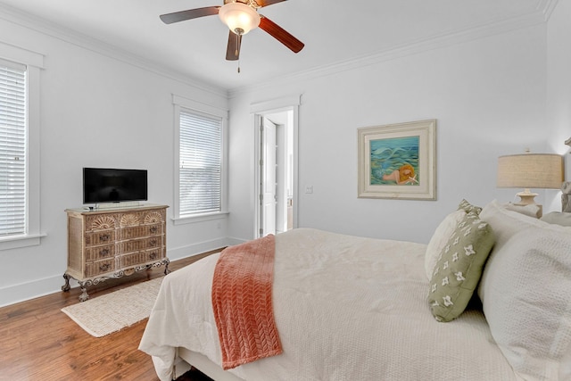 bedroom featuring wood-type flooring, ceiling fan, and ornamental molding