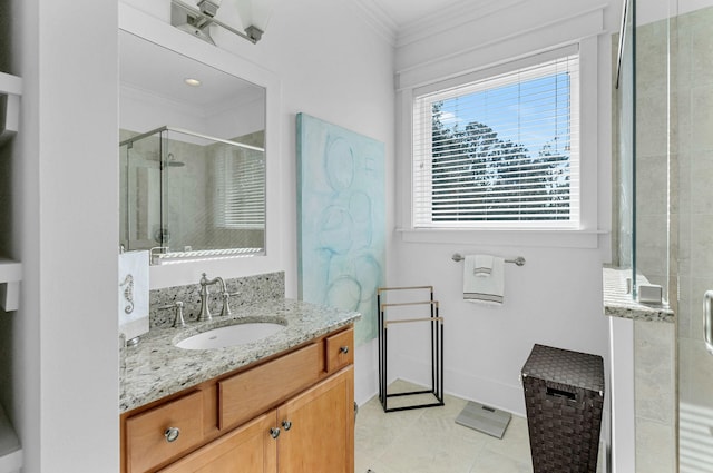 bathroom featuring tile patterned floors, vanity, a shower with shower door, and crown molding