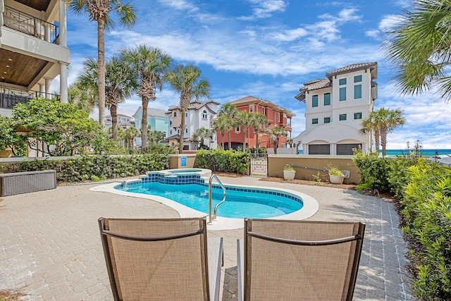 view of swimming pool with an in ground hot tub and a patio