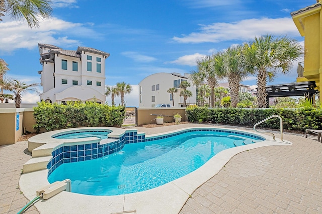 view of pool featuring a patio area and an in ground hot tub