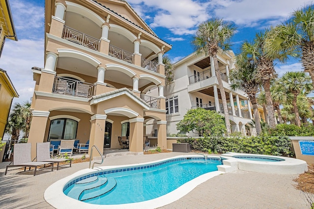 view of swimming pool with a patio area and an in ground hot tub