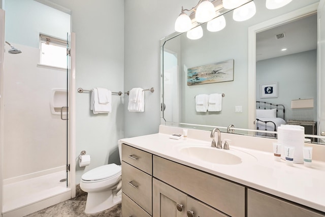 bathroom with vanity, toilet, and a shower