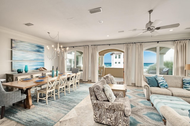 dining room with ceiling fan with notable chandelier, a water view, and ornamental molding