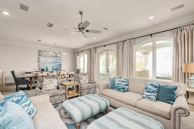 living room with crown molding and ceiling fan with notable chandelier