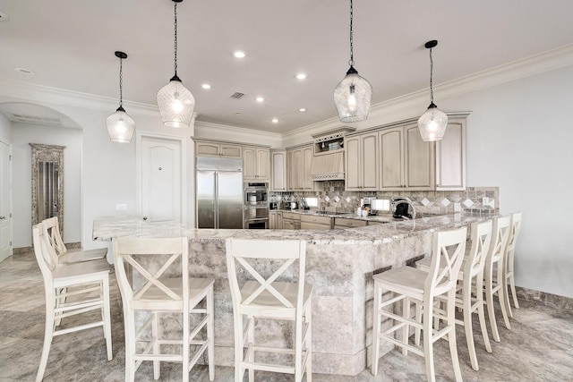 kitchen featuring decorative backsplash, decorative light fixtures, kitchen peninsula, and appliances with stainless steel finishes