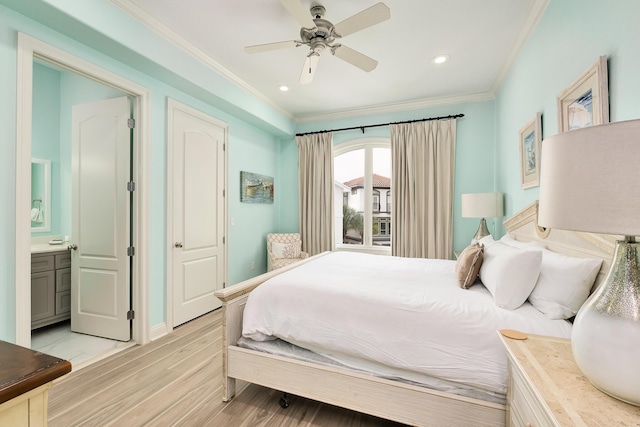 bedroom featuring ceiling fan, light hardwood / wood-style floors, crown molding, and connected bathroom