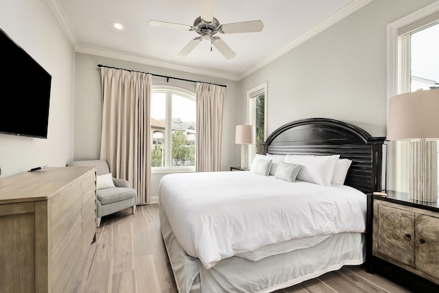 bedroom with ceiling fan, light hardwood / wood-style flooring, and ornamental molding