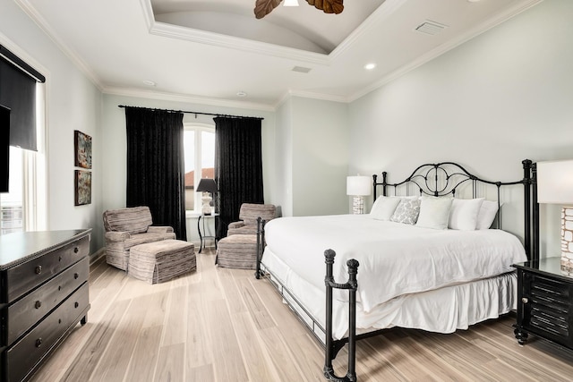 bedroom with ceiling fan, lofted ceiling, crown molding, and light hardwood / wood-style flooring