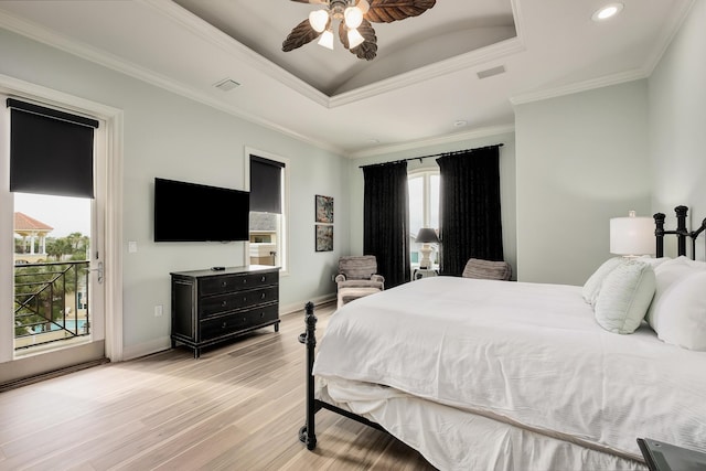 bedroom featuring ornamental molding, access to outside, a raised ceiling, ceiling fan, and hardwood / wood-style floors