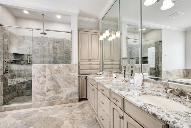 bathroom featuring vanity, a shower with door, and ornamental molding