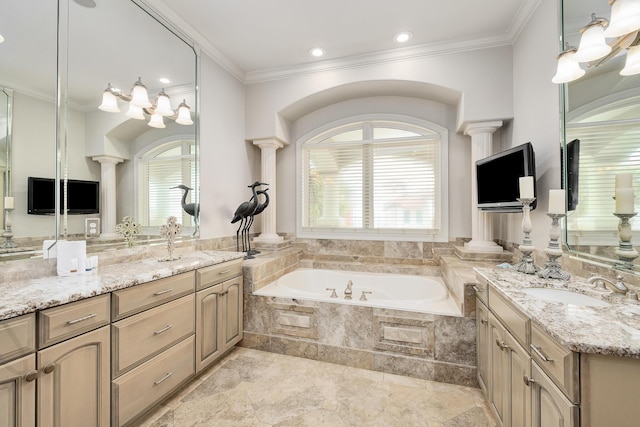 bathroom featuring vanity, a relaxing tiled tub, ornate columns, and crown molding