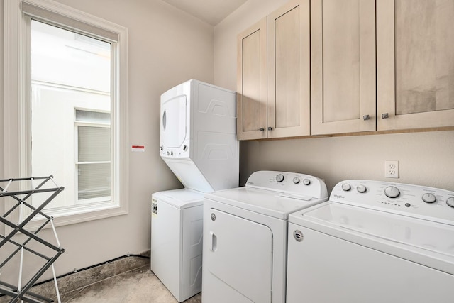 laundry area featuring washer and clothes dryer and cabinets