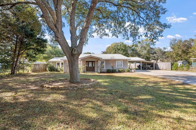 ranch-style house with a carport and a front yard