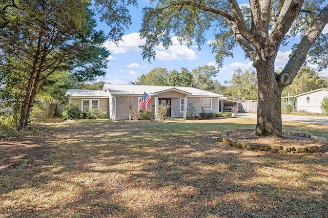 ranch-style home featuring a carport and a front lawn