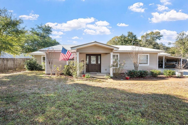 view of front of property with a front yard and a carport