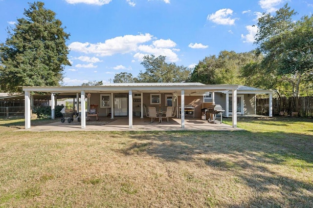 rear view of house with a patio area and a yard