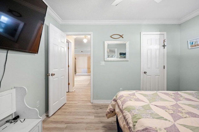 bedroom with crown molding and light hardwood / wood-style flooring