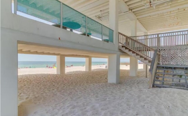 interior space with a water view and a view of the beach