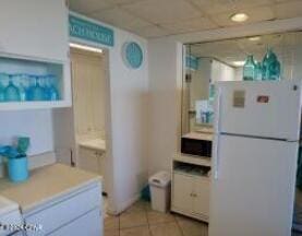 kitchen featuring white cabinets, white refrigerator, and light tile patterned floors