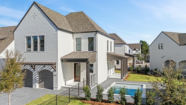 view of front of property featuring a front yard and a garage