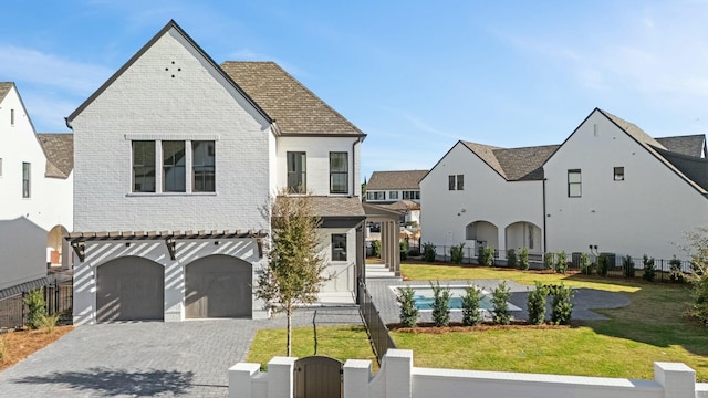 view of front of property with a garage and a front yard