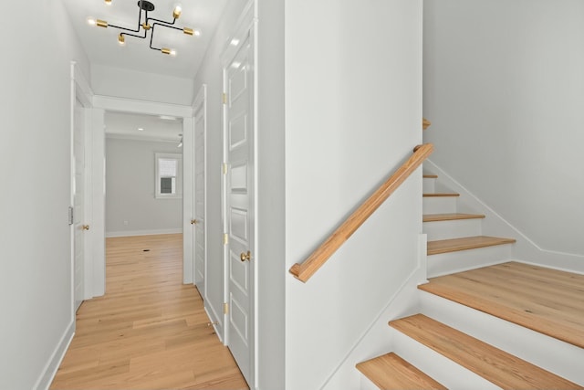 interior space with a notable chandelier and light wood-type flooring