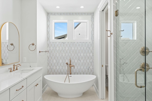 full bathroom featuring tile patterned flooring, shower with separate bathtub, vanity, and toilet