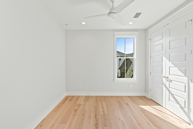 unfurnished bedroom with ceiling fan, a closet, and light hardwood / wood-style floors