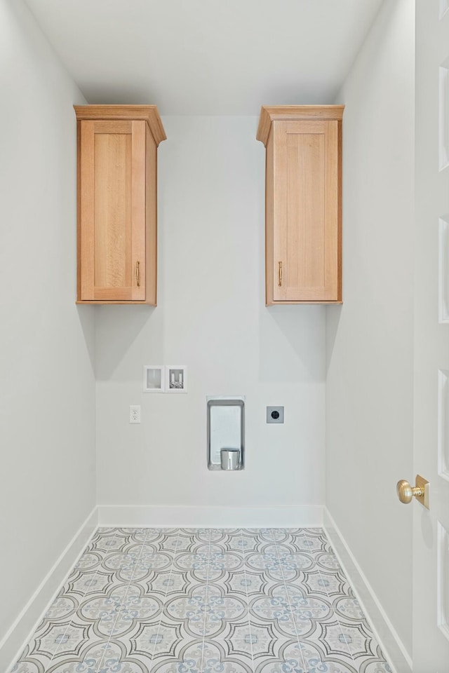 clothes washing area with hookup for an electric dryer, hookup for a washing machine, light tile patterned floors, and cabinets