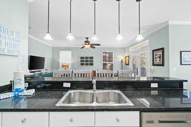 kitchen with dishwasher, ornamental molding, sink, and hanging light fixtures