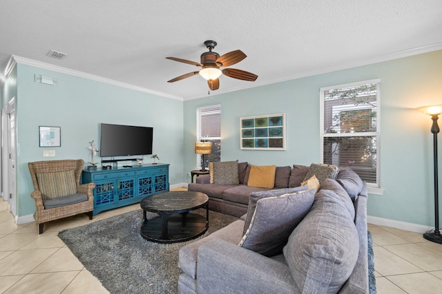 living room featuring ceiling fan, light tile patterned flooring, a textured ceiling, and ornamental molding