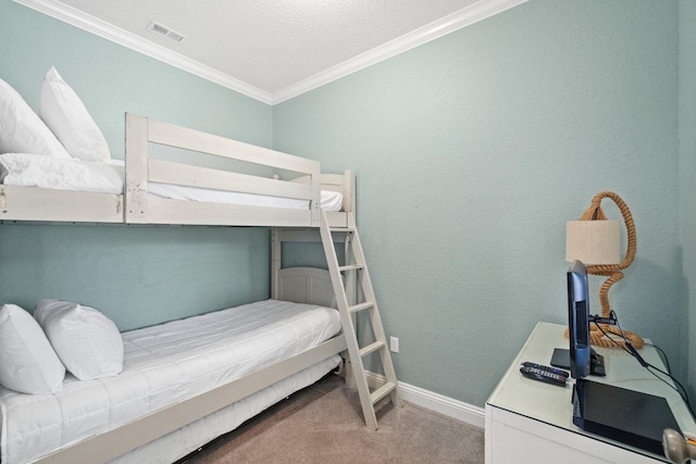 bedroom with a textured ceiling, carpet floors, and crown molding