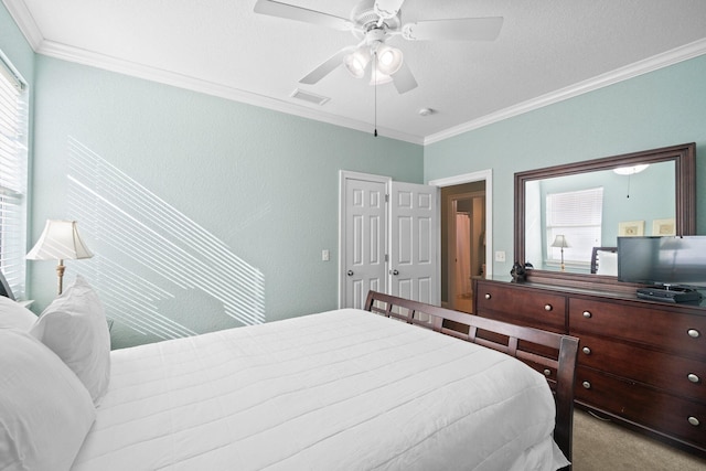 bedroom featuring multiple windows, light carpet, crown molding, and ceiling fan