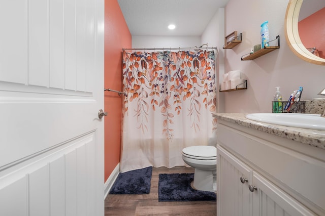 full bathroom featuring vanity, hardwood / wood-style flooring, toilet, and shower / bathtub combination with curtain