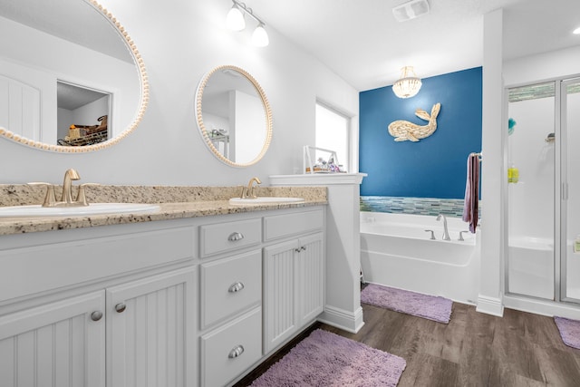 bathroom with vanity, independent shower and bath, and hardwood / wood-style flooring