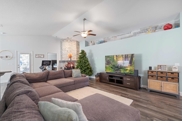 living room featuring ceiling fan, dark wood-type flooring, and vaulted ceiling