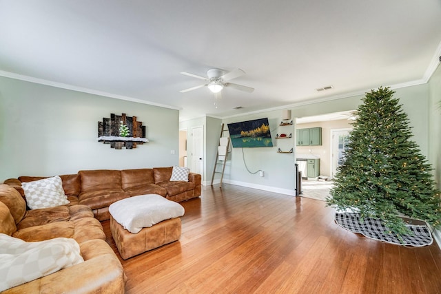 living room featuring crown molding, ceiling fan, and hardwood / wood-style flooring