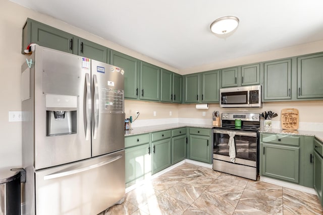 kitchen with stainless steel appliances and green cabinetry