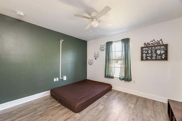 bedroom with wood-type flooring and ceiling fan